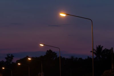 Low angle view of illuminated street light against sky at sunset