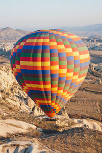 Hot air balloons flying over land