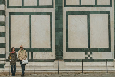 Rear view of man standing against window