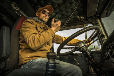 Portrait of man sitting in car