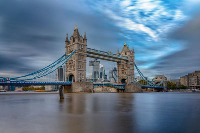 View of bridge over river against cloudy sky