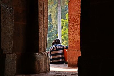 Rear view of woman playing guitar