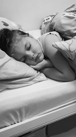 Close-up of baby sleeping on bed at home