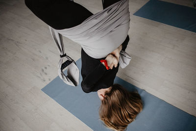 Rear view of women sitting on hardwood floor