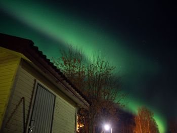 Low angle view of illuminated building against sky at night