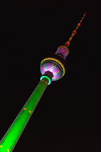 Low angle view of communications tower at night