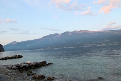 Scenic view of sea and mountains against sky