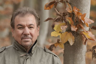 Portrait of man with leaves outdoors