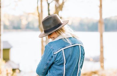 Side view of woman wearing hat standing outdoors