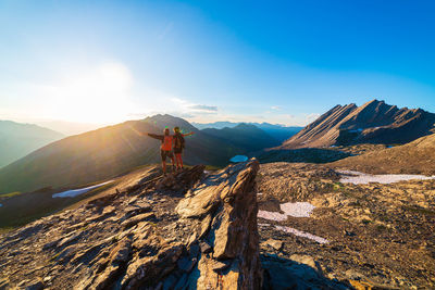 Panoramic view of man walking on mountain against sky