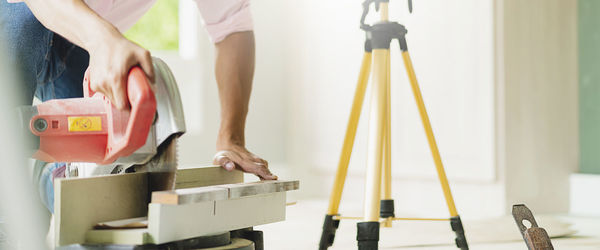 Low section of man working on table