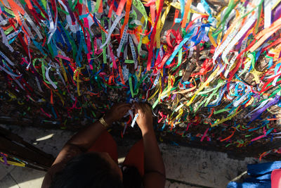 A catholic person is seen touching the remembrance ribbons during mass on the last friday of 2024 