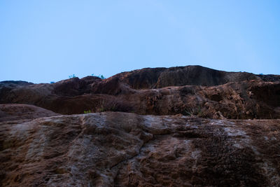 Scenic view of rocky mountains against clear blue sky