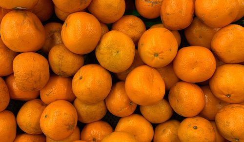 A pile of fresh orange in the market, great for your design and texture background