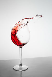 Red wine in glass against white background