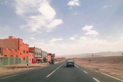 Cars on road against sky