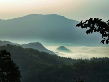 Scenic view of mountains against cloudy sky