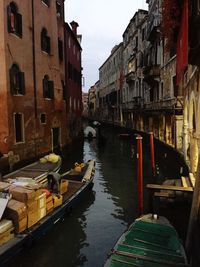 Boats in canal along buildings