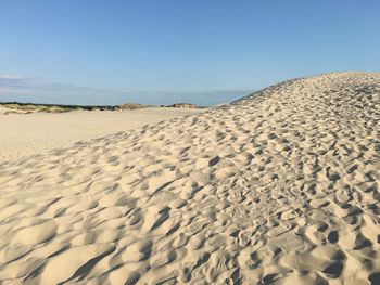 Sand dune in desert against clear blue sky