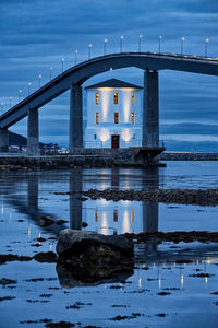 Lepsøyrevet lighthouse with lepsøy bridge in the background, haramsøya, Ålesund, norway.
