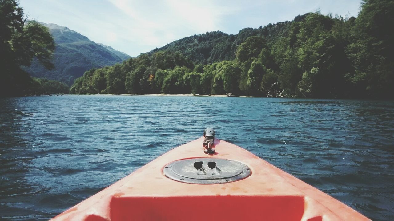 CLOSE-UP OF BOAT IN LAKE AGAINST TREES