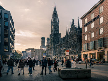 Group of people walking on street in city