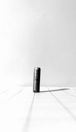 Close-up of metallic object on table against white background