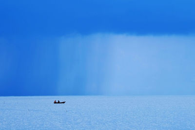 Scenic view of sea against blue sky