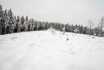 Scenic view of snow covered field against sky