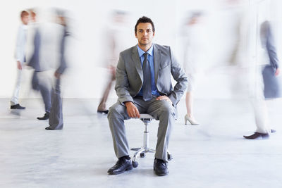 Portrait of businessman sitting on chair