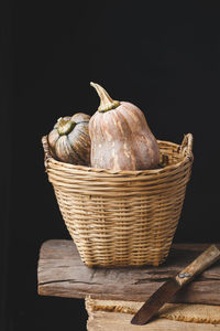 Close-up of wicker basket against black background