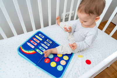 High angle view of boy playing with toys on table