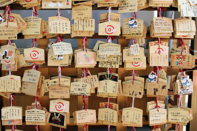 Full frame shot of text hanging outside temple