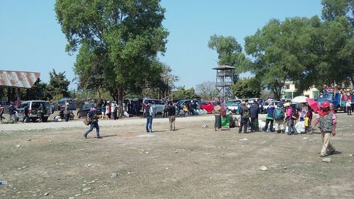 Group of people against plants in city