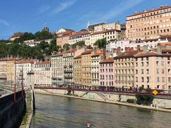 River by buildings in town