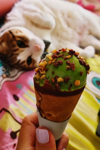 Close-up of hand holding ice cream cone