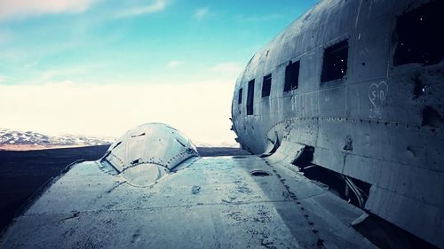 Abandoned airplane against sky