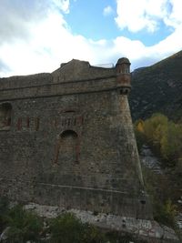 Castle on mountain against sky