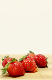 Close-up of strawberries on table against white background