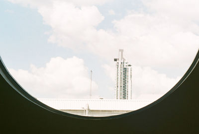 Low angle view of buildings against cloudy sky