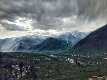 Scenic view of mountains against cloudy sky