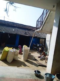 Clothes drying on roof outside building against sky