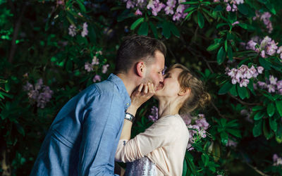Young couple kissing by tree