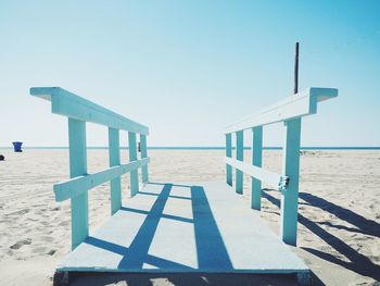 Lifeguard hut on beach against clear sky