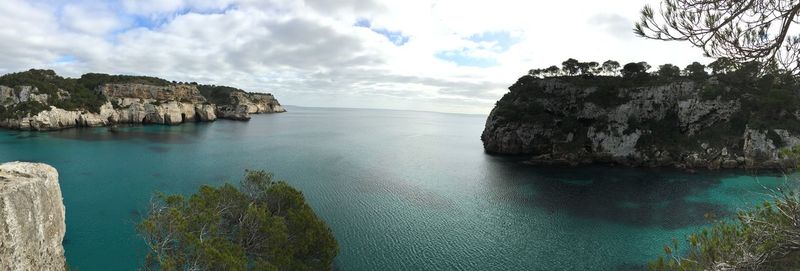 Rock formations by sea against sky