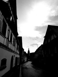 Street amidst buildings against sky