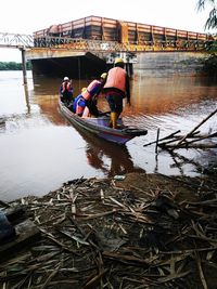 People working on boat in river