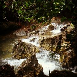 Scenic view of river flowing through rocks