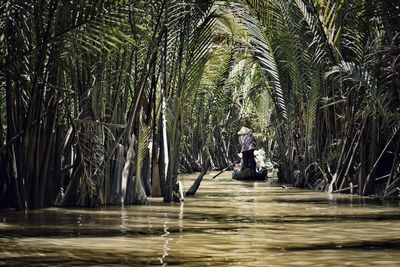 Rear view of man paddling