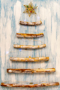 An original alternative christmas tree made from branches and decorated with a tiny garland.